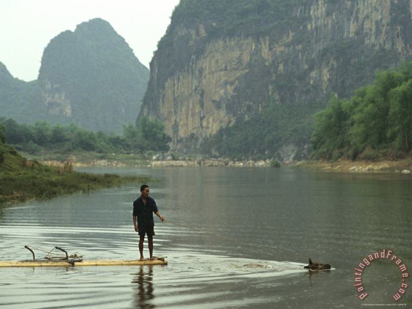 Raymond Gehman A Water Buffalo Pulls a Farmer on Bamboo Raft Across Mingjiang River Art Print