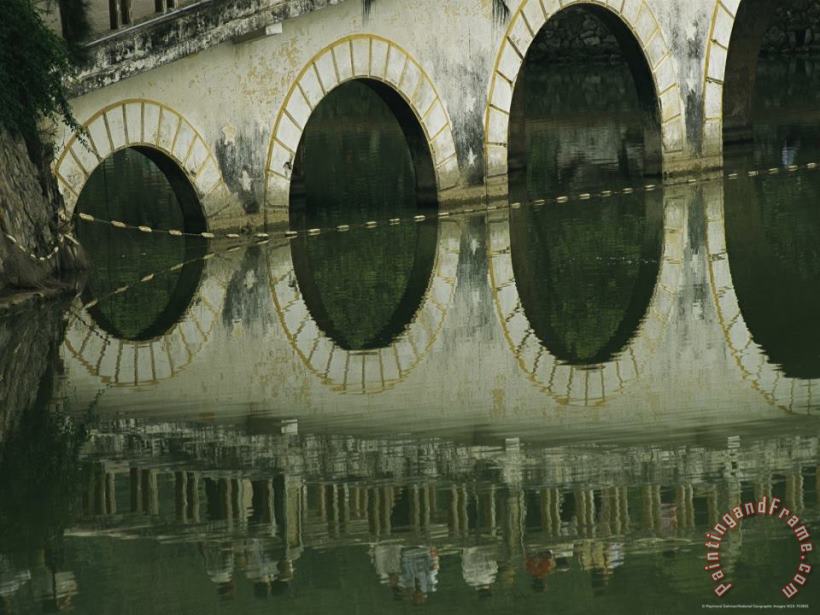 Reflections of a Gracefully Arched Bridge in Calm Water painting - Raymond Gehman Reflections of a Gracefully Arched Bridge in Calm Water Art Print