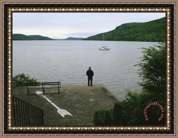 Raymond Gehman A Man Looks Out at a Sailboat Anchored on Otsego Lake Framed Print