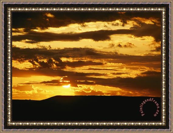 Raymond Gehman Clouds Are Colored Shades of Orange by The Low Sun Over 70 Mile Butte Framed Print