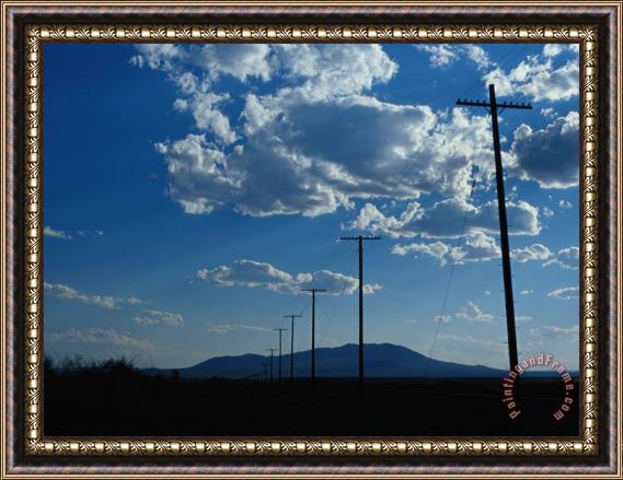 Raymond Gehman Silhouetted Telephone Poles Under Puffy Clouds Framed Painting