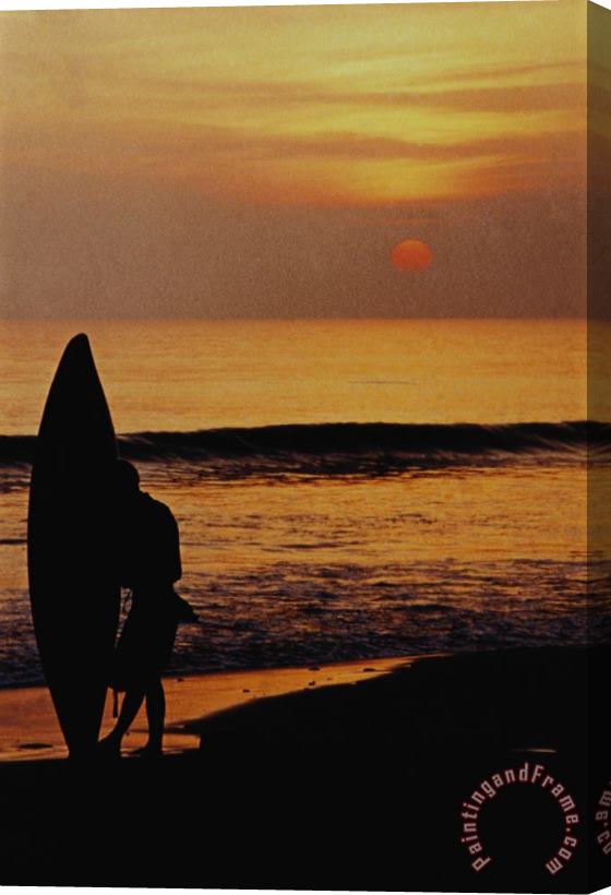 Others Surfing At Sunset Stretched Canvas Print / Canvas Art