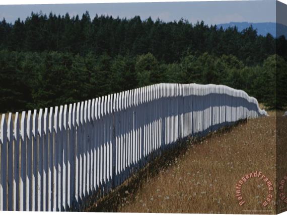 Raymond Gehman A White Picket Fence Recedes Down a Field Stretched Canvas Painting / Canvas Art
