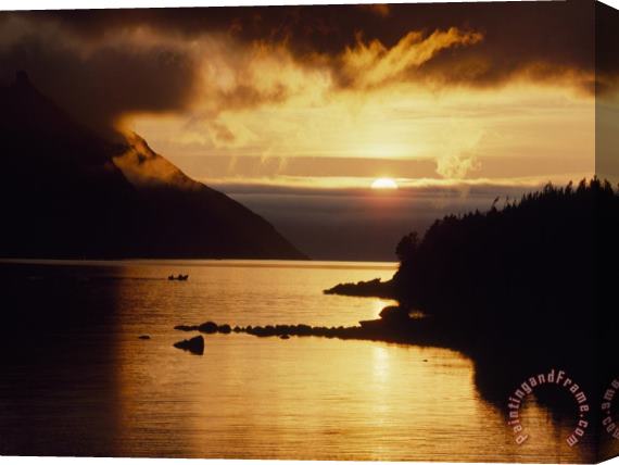 Raymond Gehman Cloud Filtered Sunset Silhouettes a Boat on The Sheltered Waters of Bonne Bay Stretched Canvas Print / Canvas Art